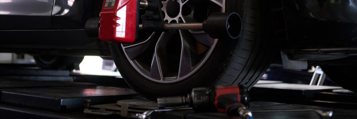 Balancing of car's tyres at auto workshop Closeup photoshoot of process or tyre balancing at dark auto service.